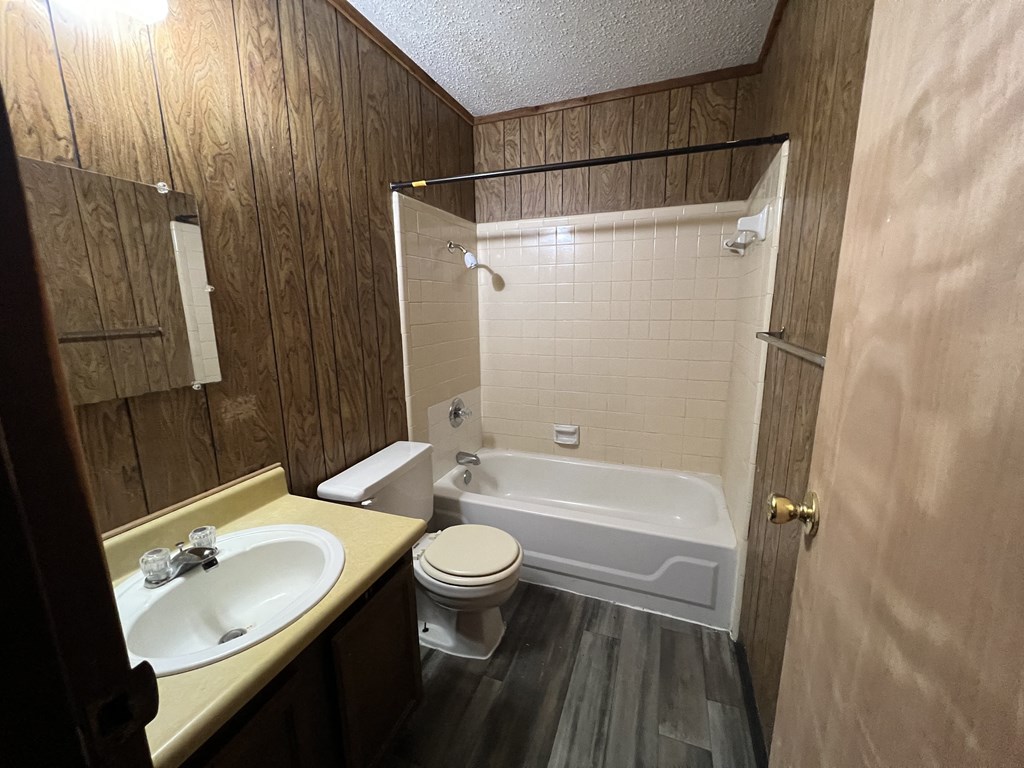 a small bathroom with a sink toilet and bath tub