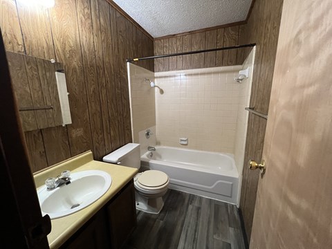 a small bathroom with a sink toilet and bath tub