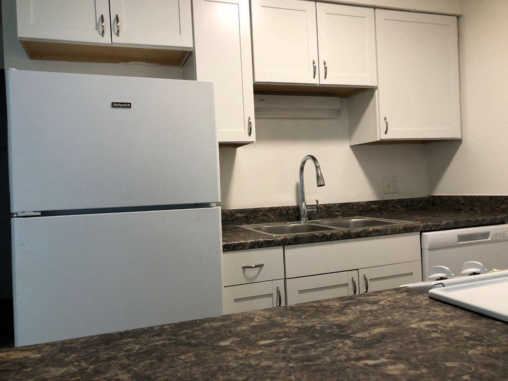 a kitchen with a sink and a refrigerator