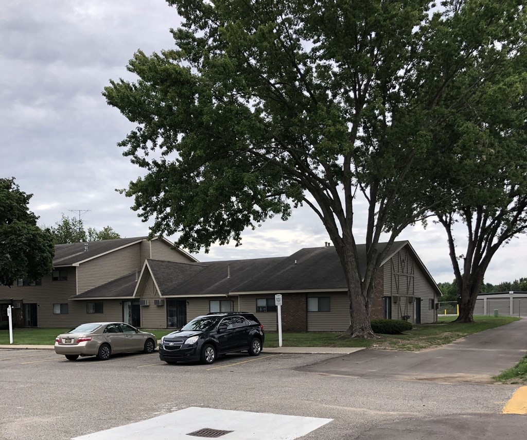 a building with two cars parked in front of it