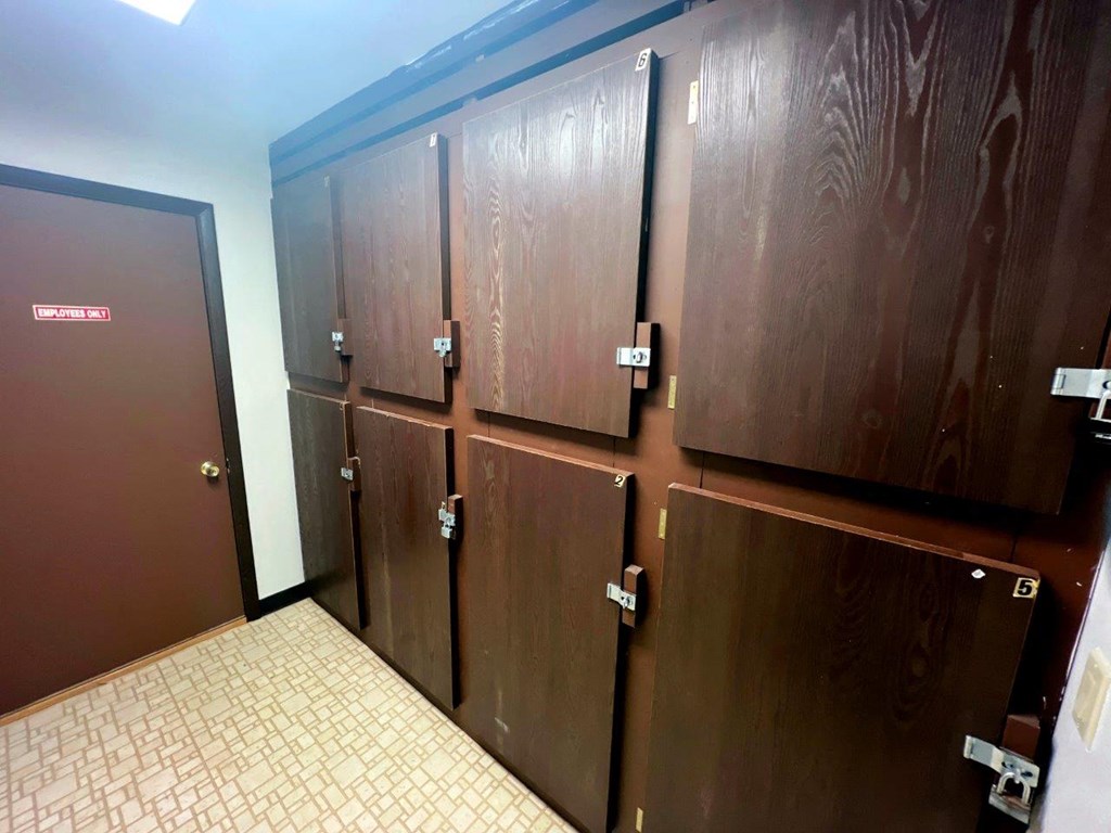 a row of wooden elevators in a building with doors