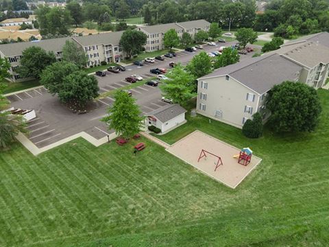 an aerial view of a playground in a parking lot