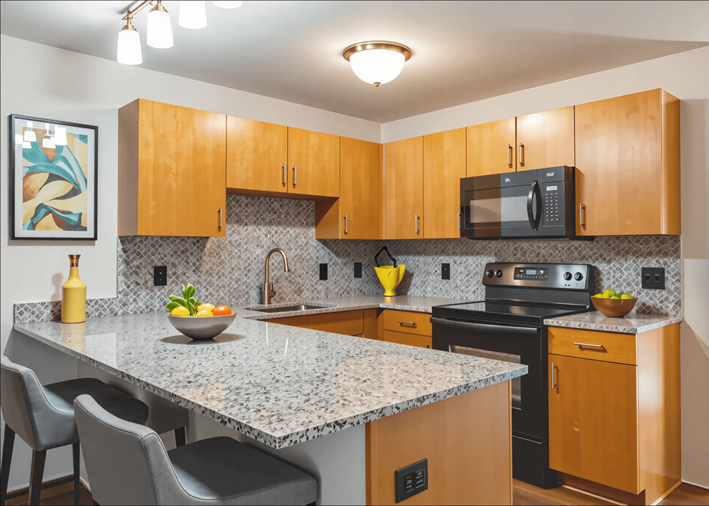 A kitchen with a granite countertop and wooden cabinets.