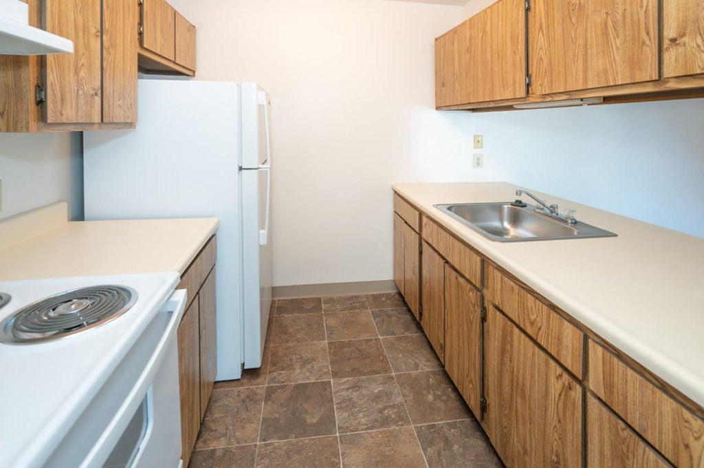 a kitchen with a stove sink and refrigerator