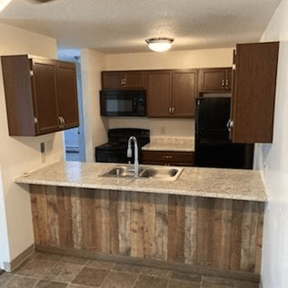 a kitchen with a sink a stove and a refrigerator