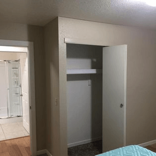 a bedroom with a bed and a closet