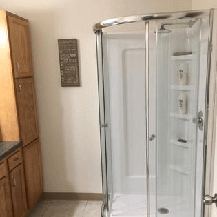 a shower with a glass door in a bathroom