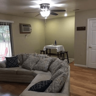 a living room with a couch and a table in the background