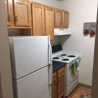 a kitchen with a refrigerator stove and cabinets