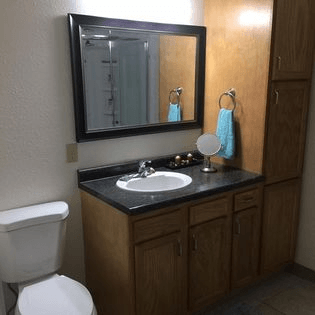 a bathroom with a sink toilet and mirror