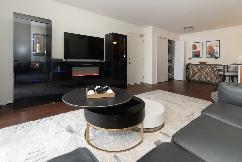 A modern living room with a black coffee table and a television.