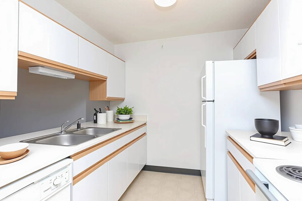 A small, clean kitchen with white cabinets and appliances.