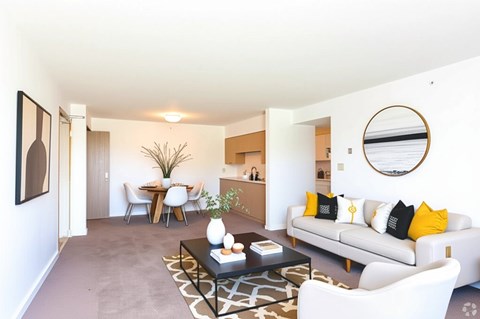 A living room with a white couch and a coffee table.