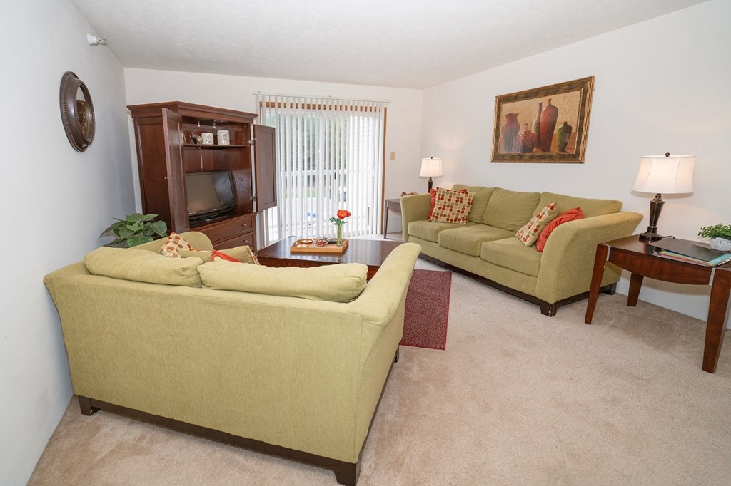 Living room view with wooden cupboard at Oates Estates Apartments, Dothan, Alabama