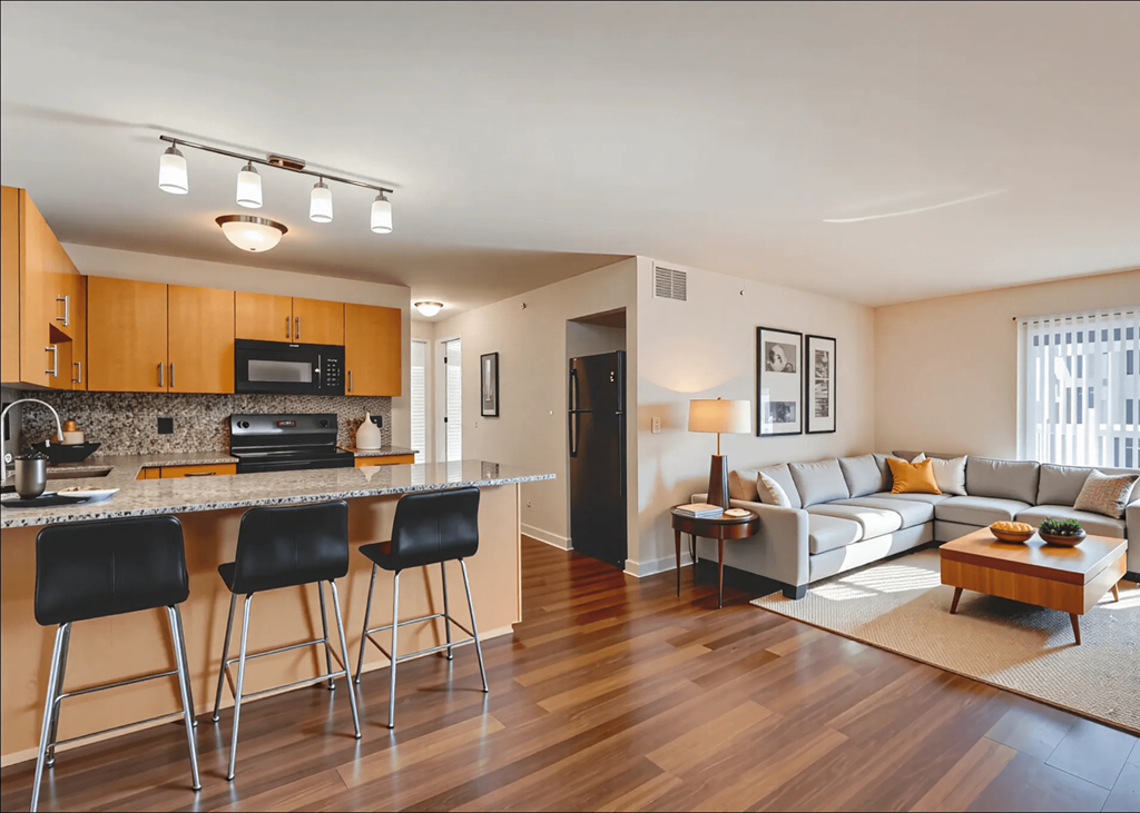 A kitchen with a bar area and a living room area.