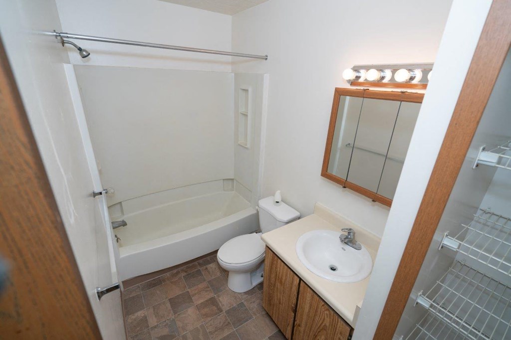 a bathroom with a sink toilet and bath tub