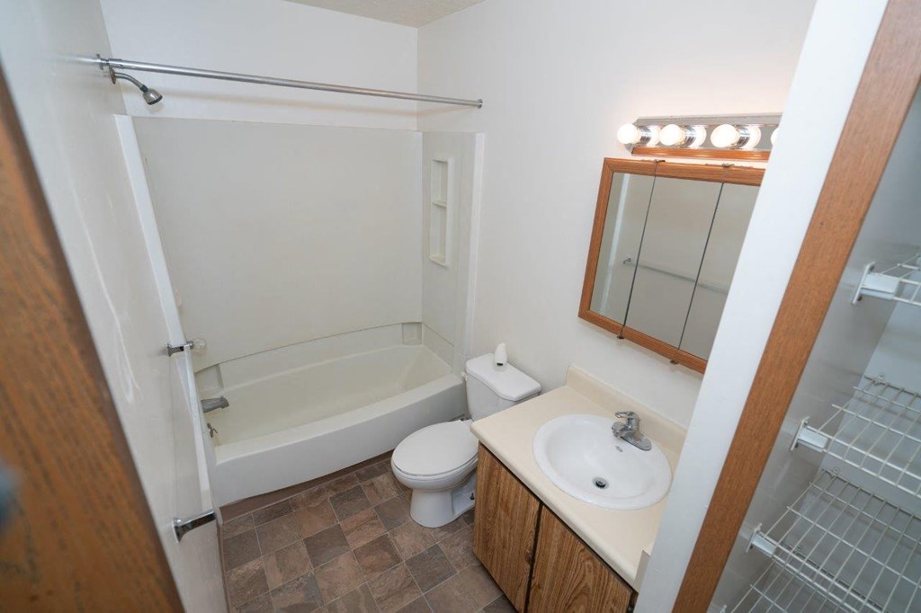 a bathroom with a sink toilet and bath tub