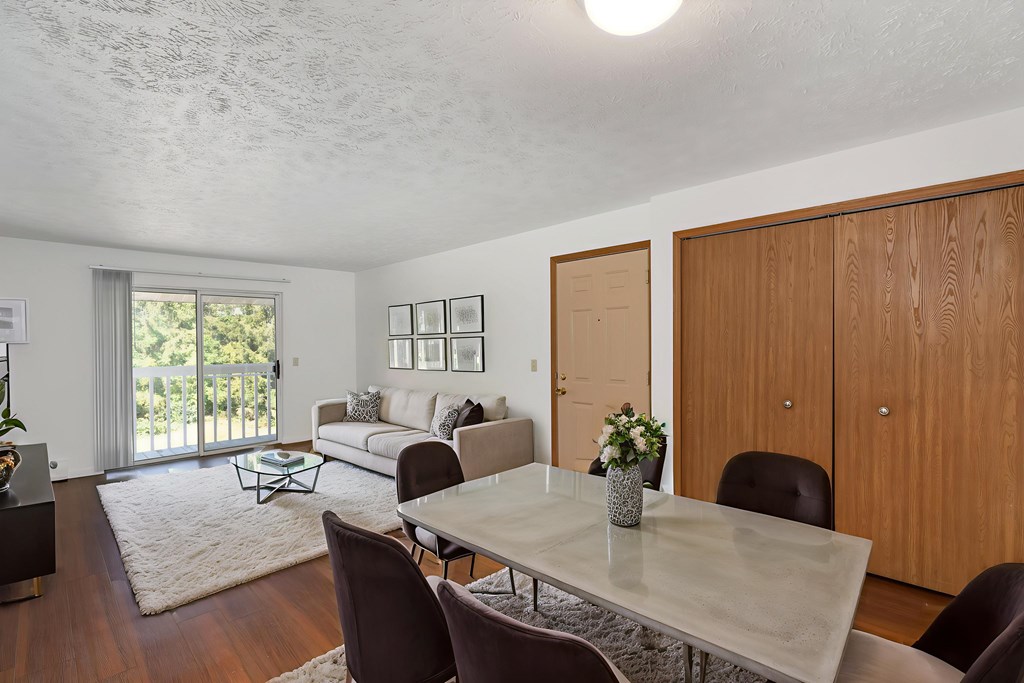 A dining room with a table and chairs.