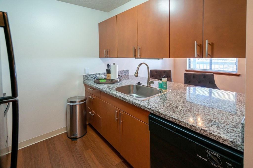 Stainless Steel Sink With Faucet In Kitchen at Raleigh House Apartments, MRD Apartments, East Lansing, MI, 48823