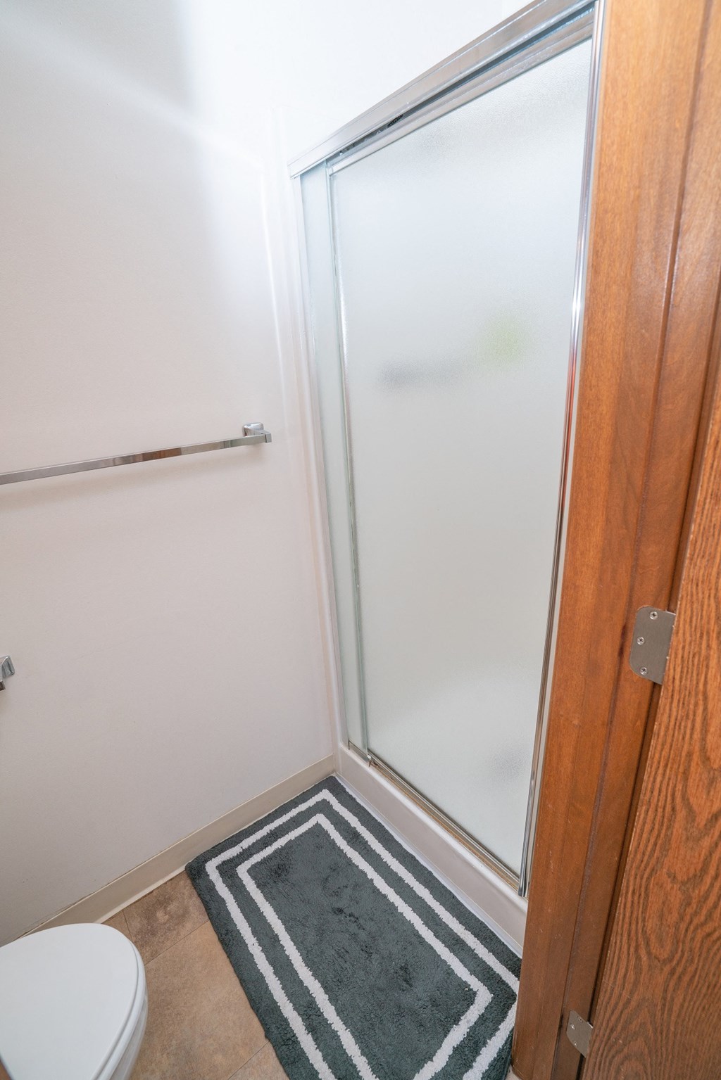 Walk In Showers With Built In Bench And Glass Enclosure at Raleigh House Apartments, MRD Apartments, Michigan, 48823