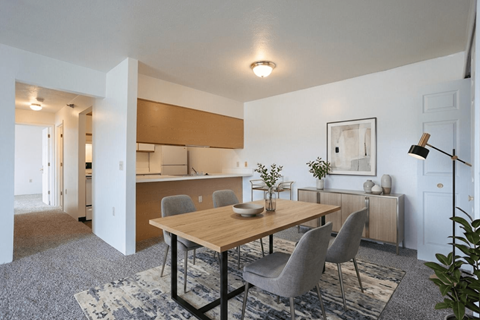 A dining room with a wooden table and grey chairs.