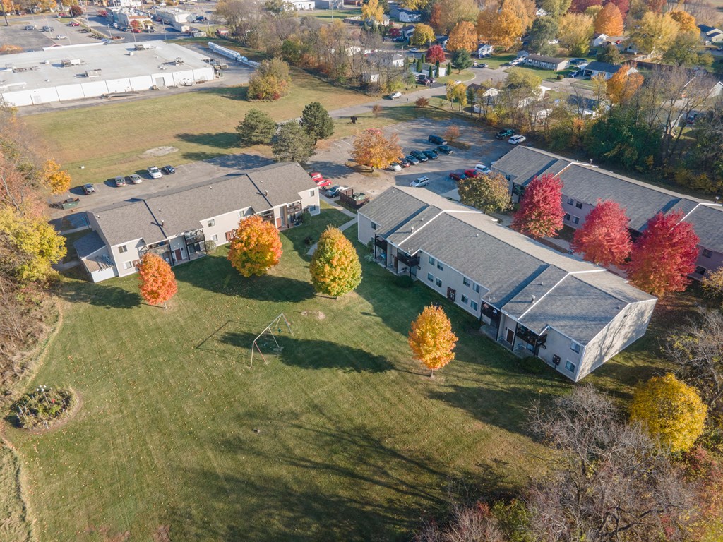 an aerial view of a group of houses in a field