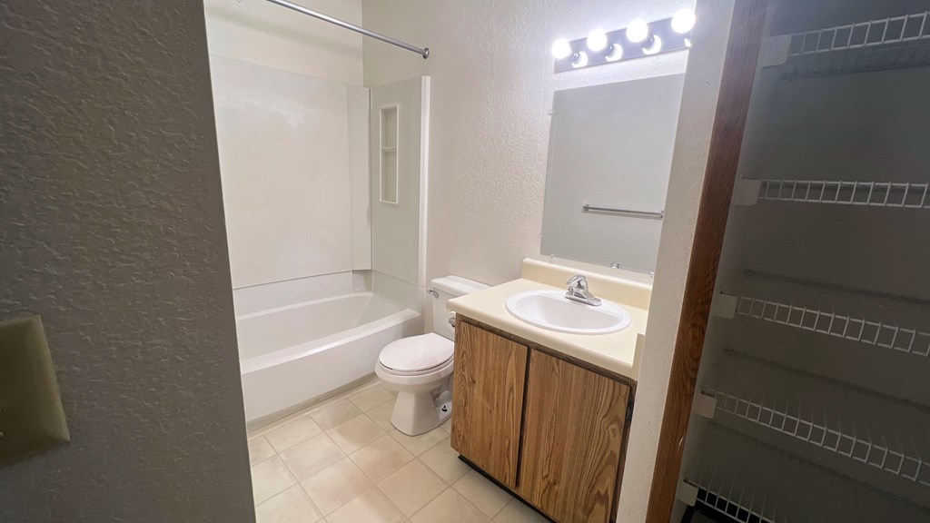 a bathroom with a sink toilet and a tub