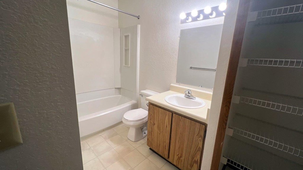 a bathroom with a sink toilet and a bath tub
