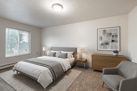 A bedroom with a large bed and a chair.