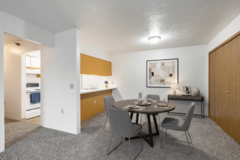 A dining room with a table set for four.