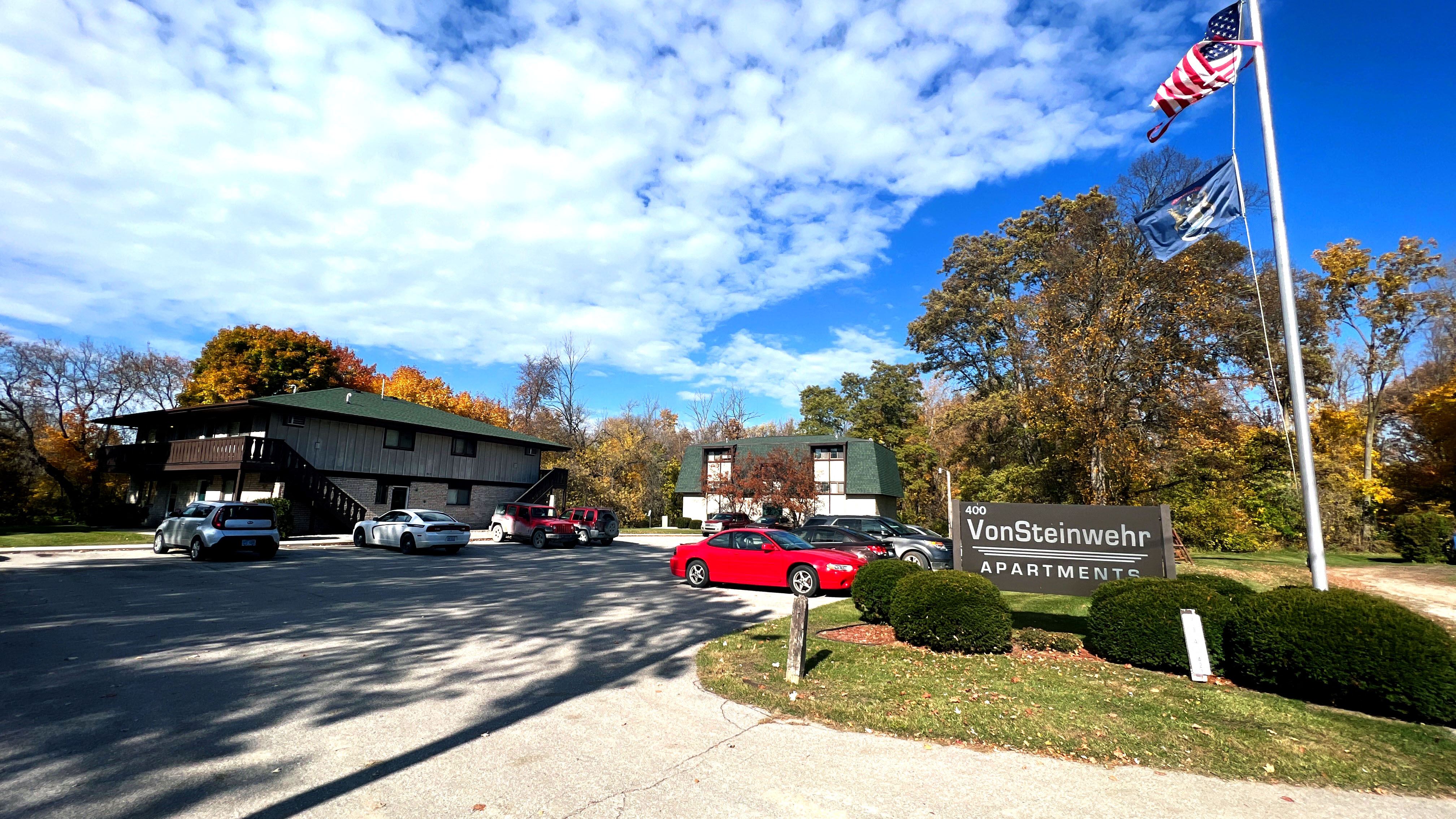 a view of the parking lot and entrance to vaughnheim apartments