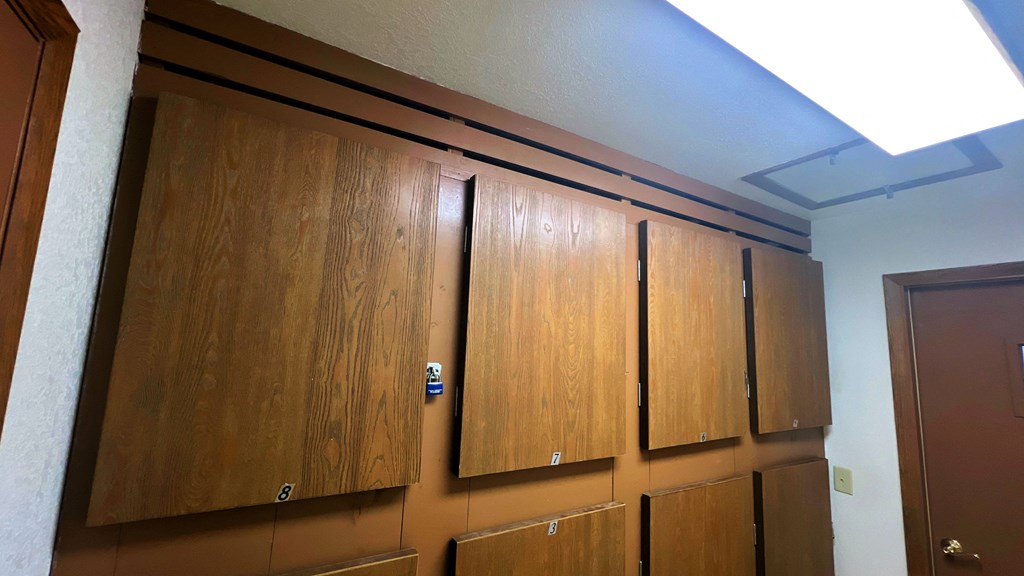 a row of wooden cabinets on the wall of a room