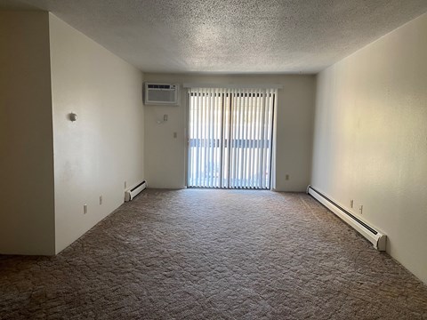 an empty living room with a sliding glass door