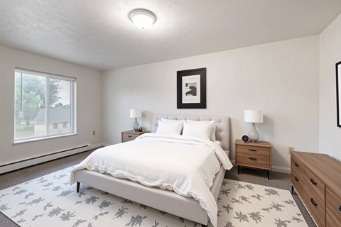 A bedroom with a large bed, two nightstands, and a framed picture on the wall.