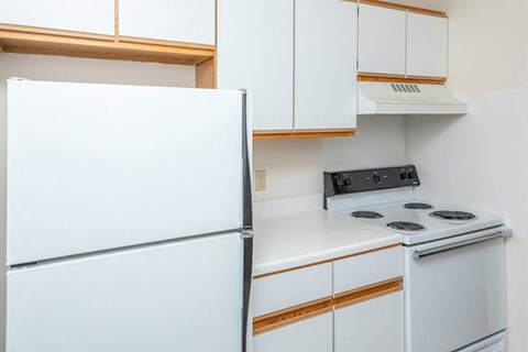 a kitchen with a white stove and a refrigerator