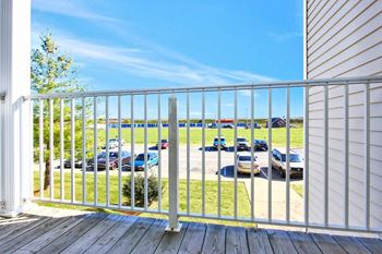 a balcony with a view of a parking lot with cars at Morris Estates Apartments in Hopkinsville, KY 42240