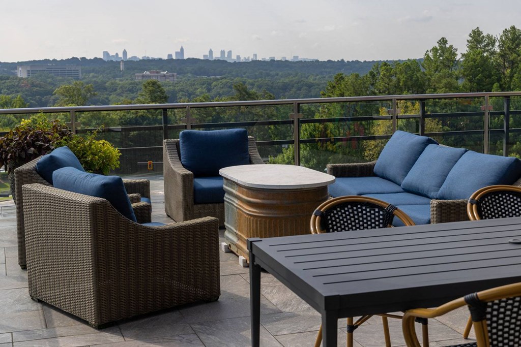 a patio with furniture and a view of the city