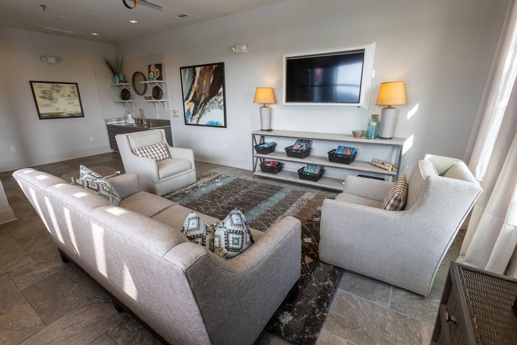 a living room with couches and chairs and a television