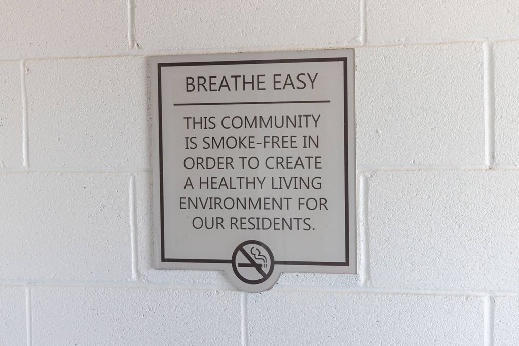 a sign that says breathe easy this community is smoke free in order to create a