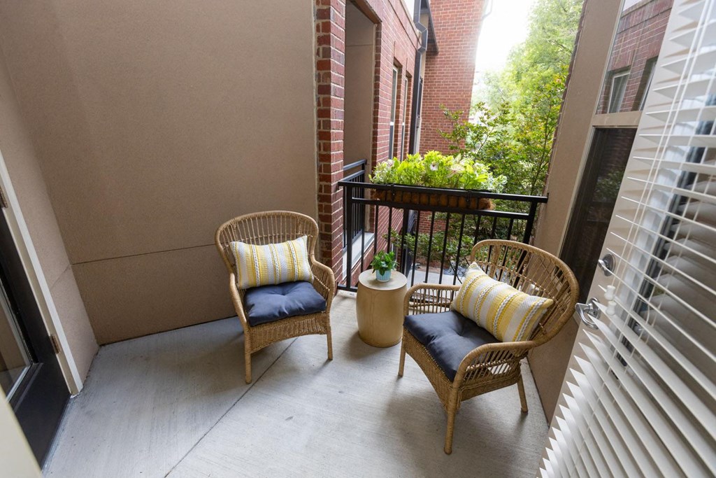 a balcony with two chairs and a table