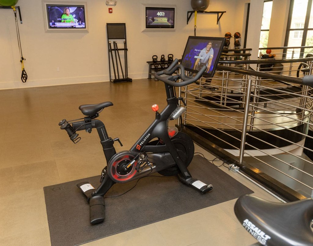 a stationary bike in a gym with a screen on it