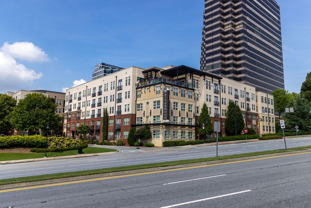 a view of an apartment building on a city street