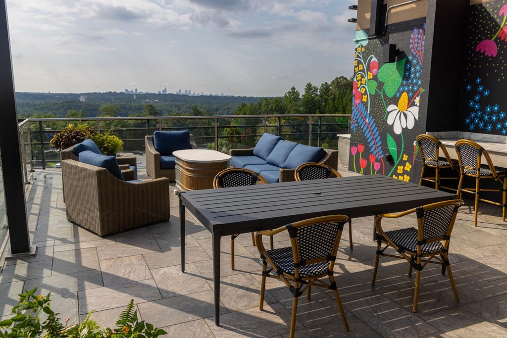 a patio with a table and chairs on a balcony