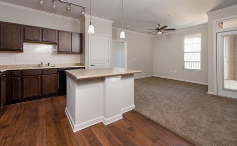 A kitchen with brown cabinets and a white island.