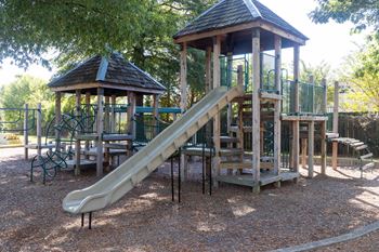 a playground with a slide and a pavilion