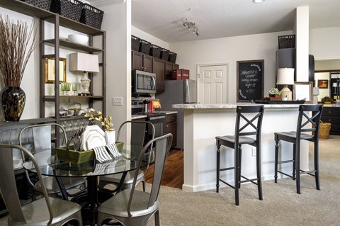 an open kitchen and dining room with a table and chairs