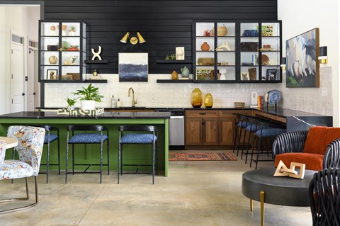 a kitchen with a green counter top and a dining room with chairs
