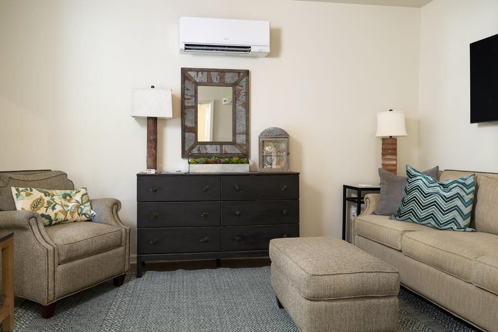 a living room filled with furniture and a flat screen tv