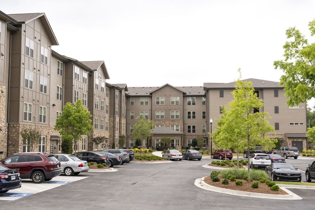 a parking lot in front of an apartment building