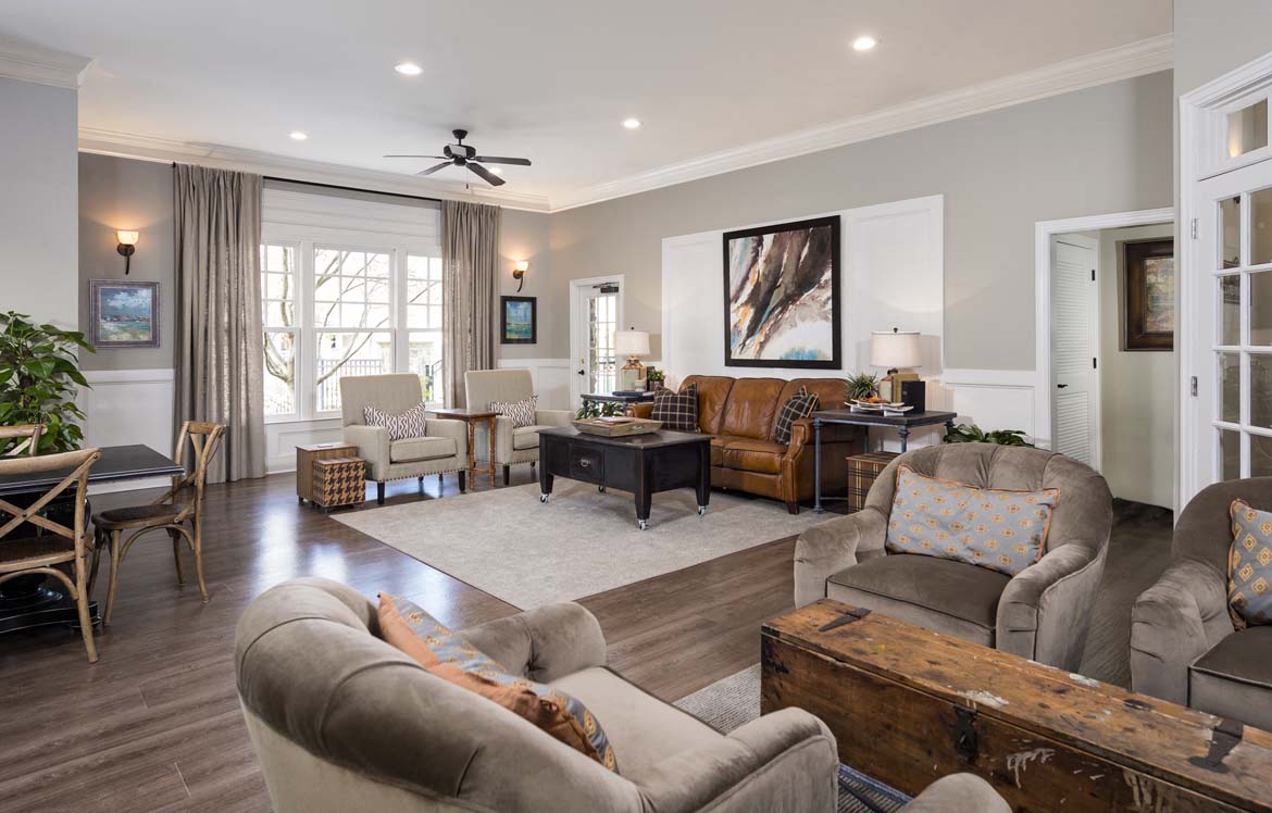 a living room with furniture and a ceiling fan